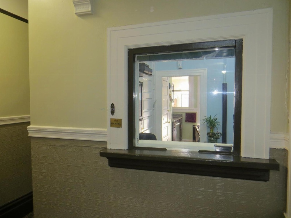 A window in a wall showing an interior view